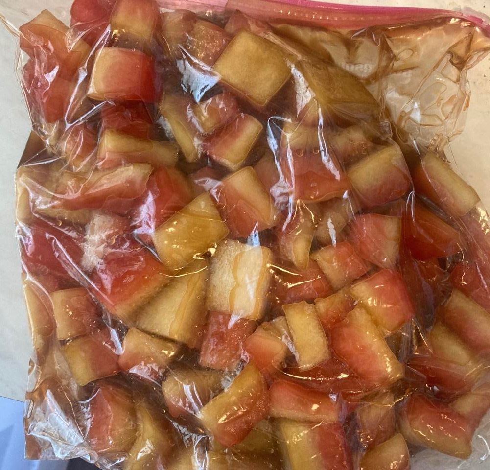 Cubed watermelon pieces pickling in the bag